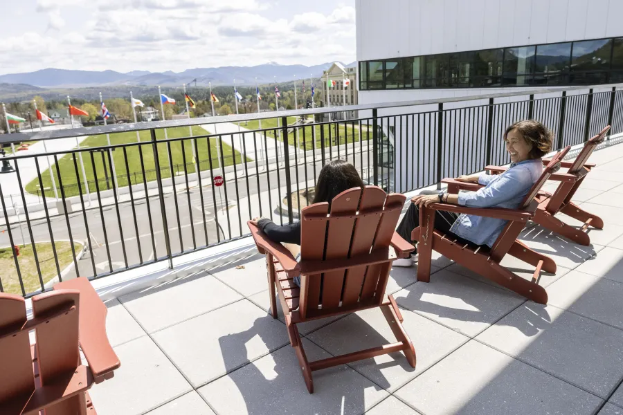 A mother and daughter sitting in Adirondack chairs