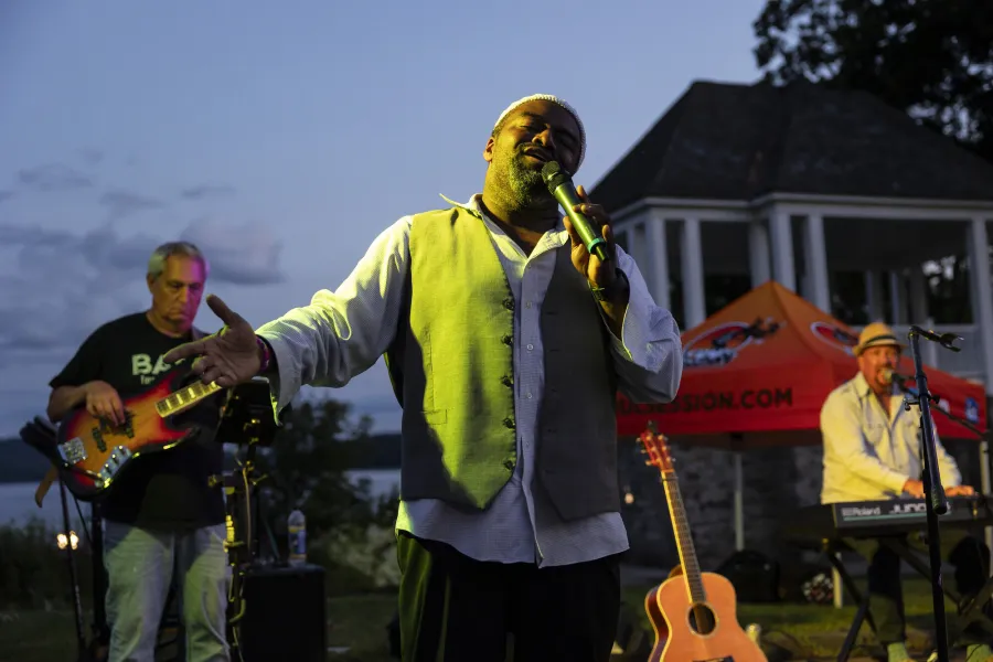 A man singing at an outdoor music festival