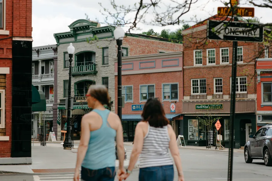 A couple walking down historic Main Street in Saranac Lake