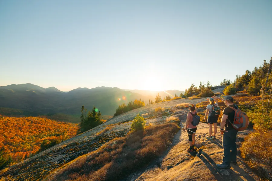 Three hikers on a fall summit