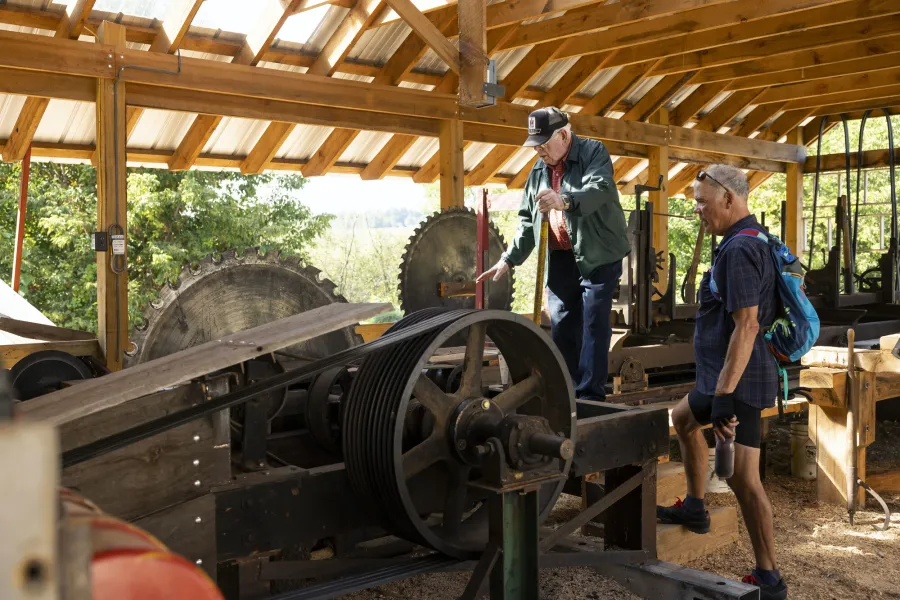 A cyclist checking out some farming equipment during an event