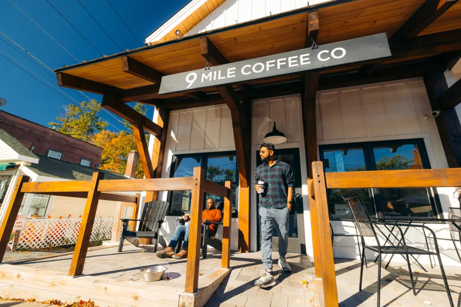 A man walking out of a coffee shop