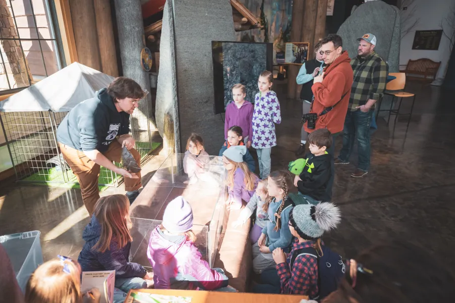 A museum worker presenting to kids