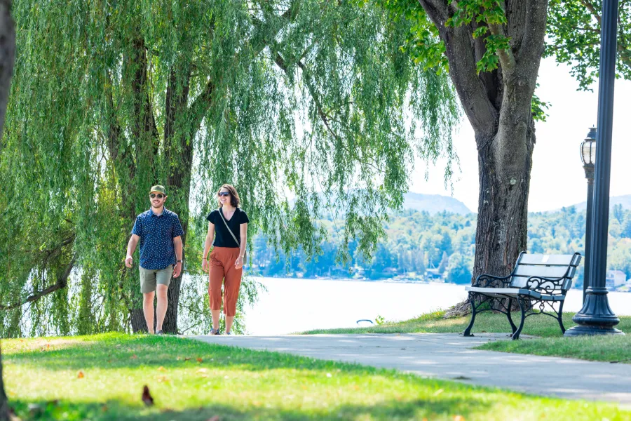 A couple walking on a lakeside path in the spring