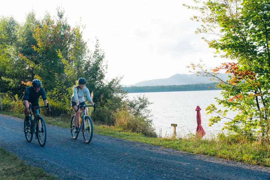 Two people cycling on a rail trail