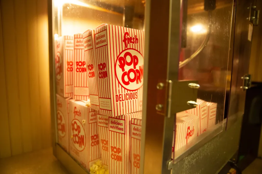 A bunch of containers of popcorn