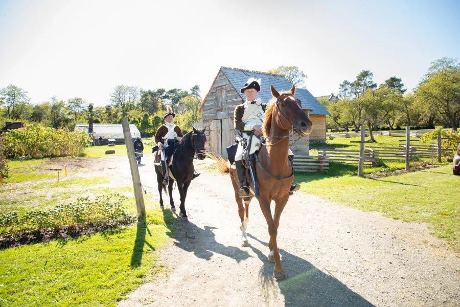 People riding horses at Fort Ticonderoga.