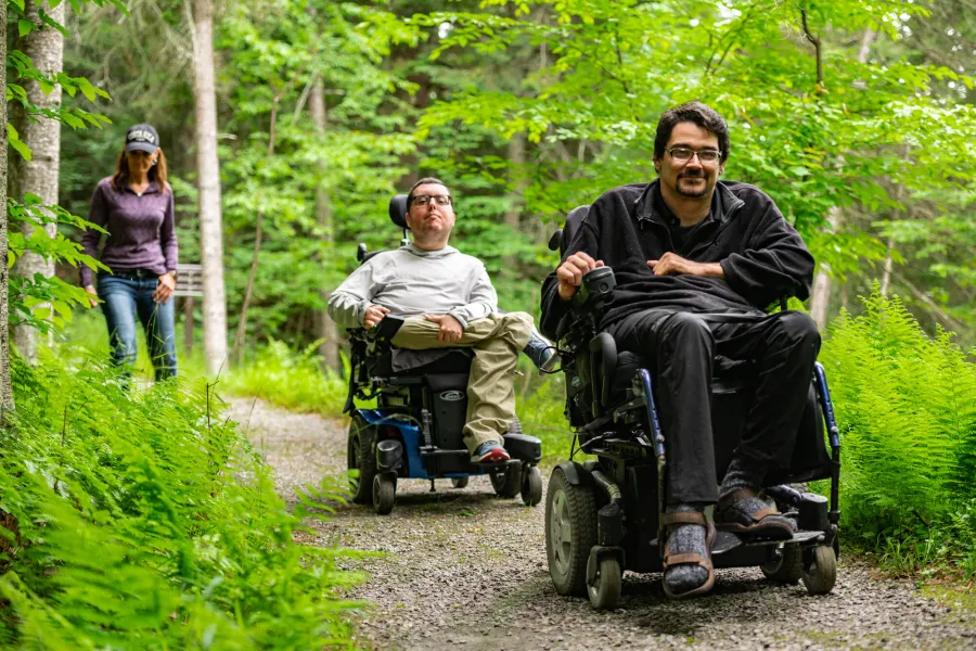Two people in wheelchairs on an accessible trail