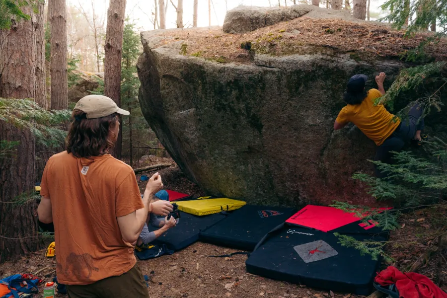A group of boulderers by a rock