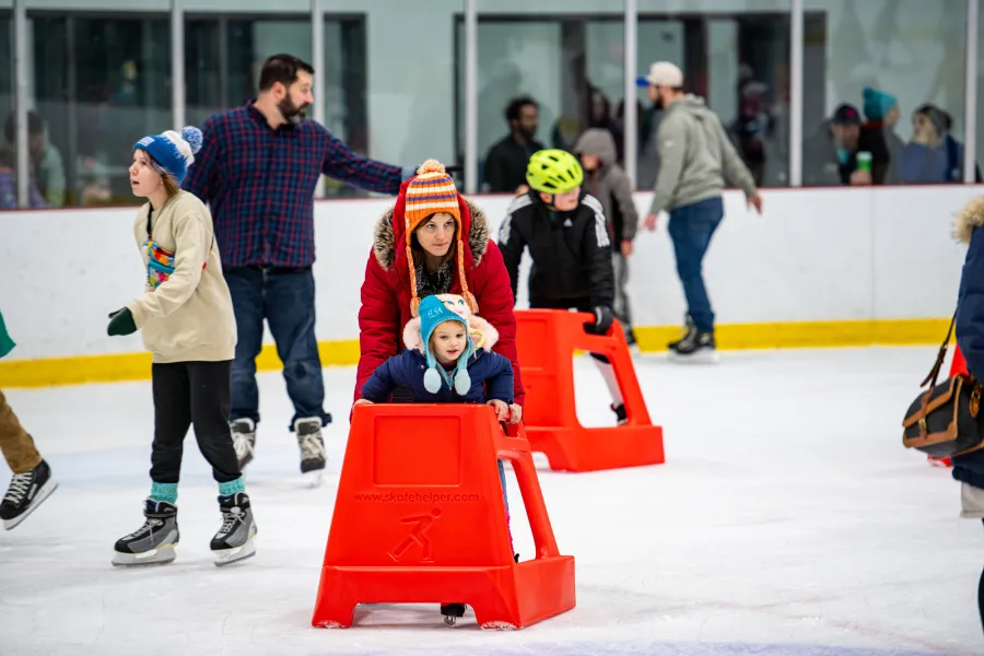A bunch of ice skaters at a rink