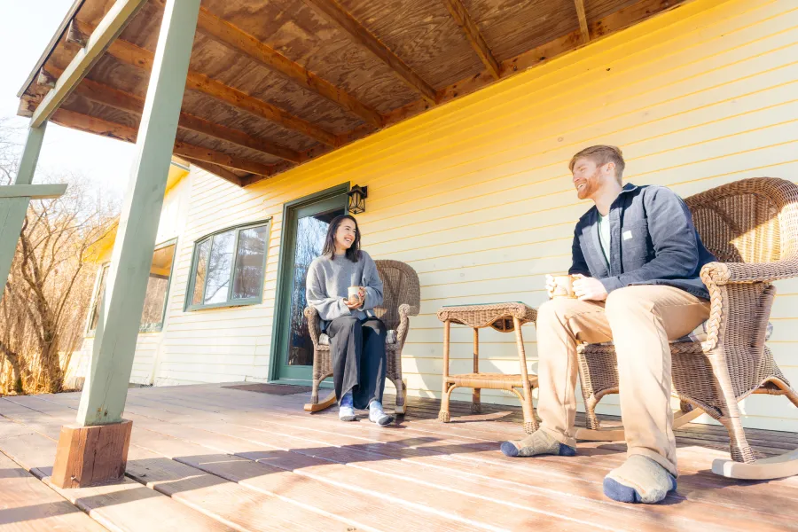 A couple sitting on a porch in the spring