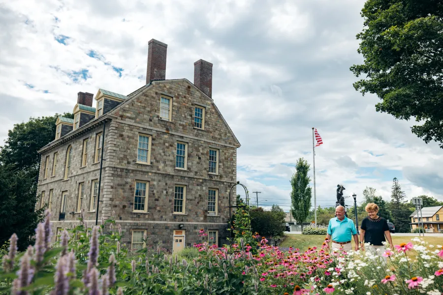 An older couple outside of historic Hancock House
