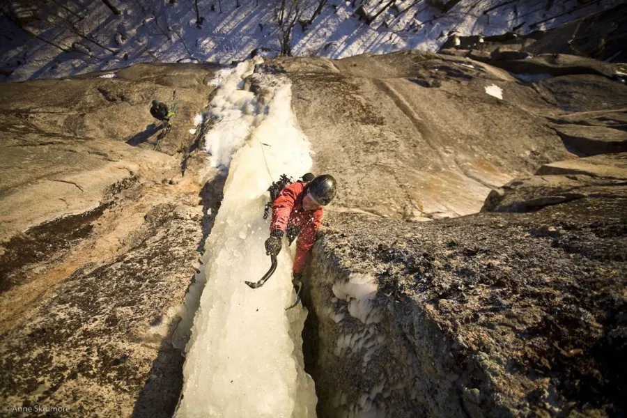 An ice climber on a narrow pillar