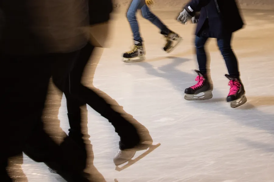 Blurry photo of ice skaters at night