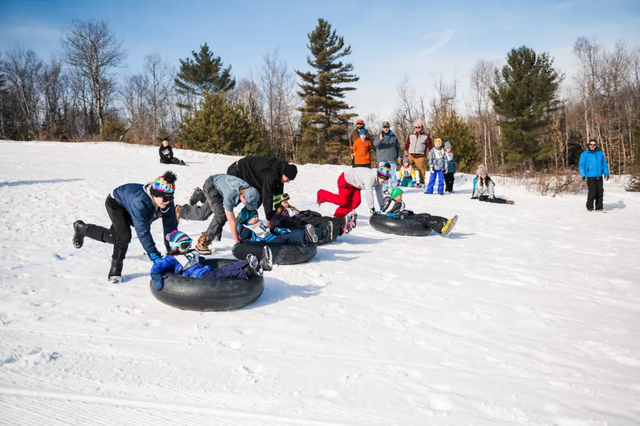 Kids tubing on a ski hill