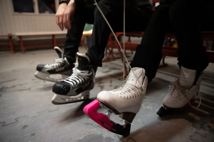 People tying up skates