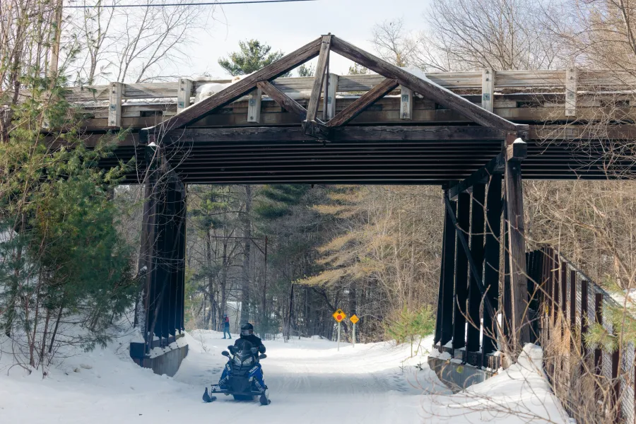 Snowmobile going under bridge