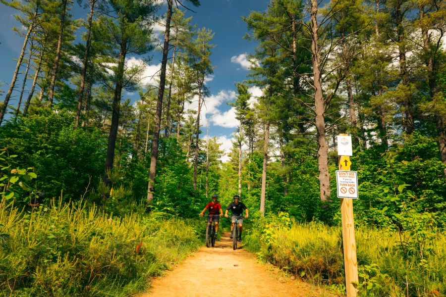 Two mountain bikers on the East Branch Community Trails