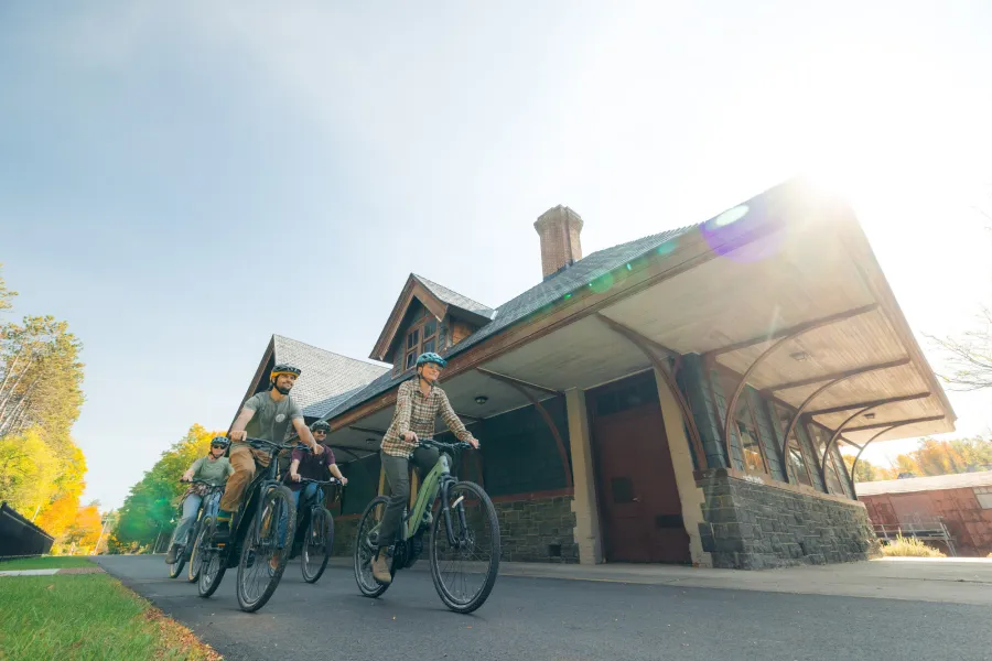 Cyclists by the Saranac Lake old train station