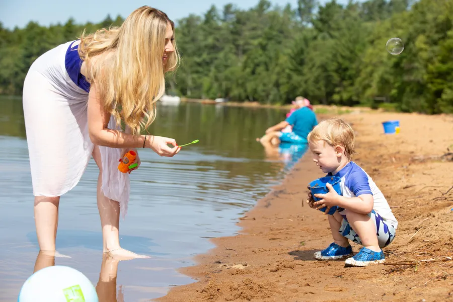 A mom and child at Lake Clear Beach.