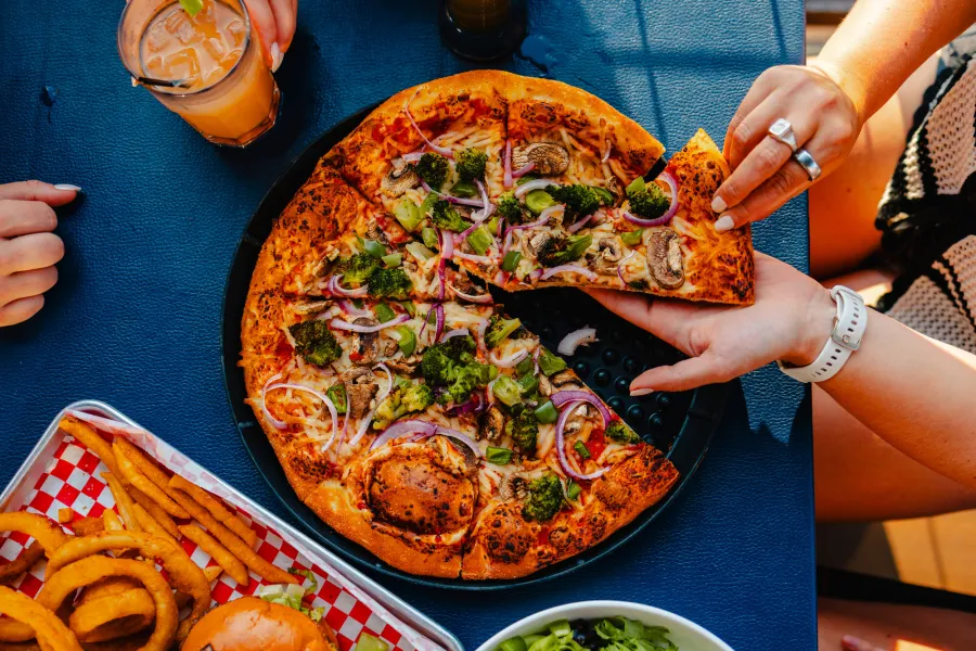 A pizza and some beer on a table