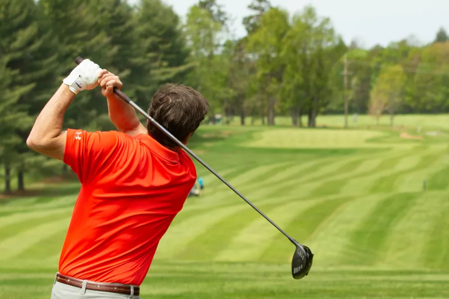 A person golfing at saranac inn