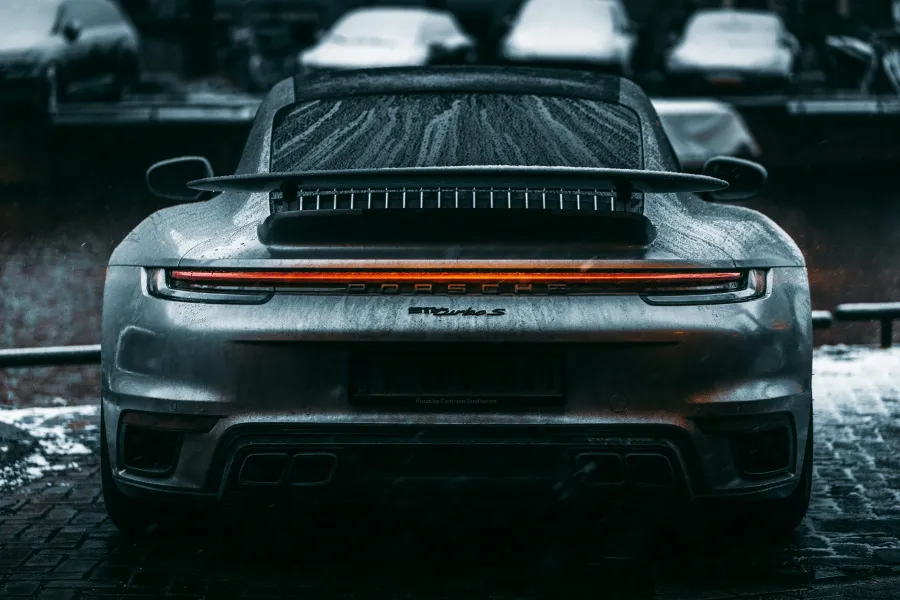 The back of a Porsche 911 car in the rain. 