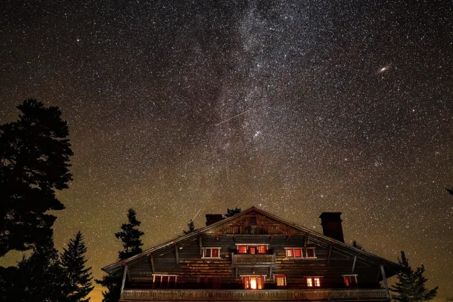 The Milky Way spreads across the sky above an Adirondack Great Camp.