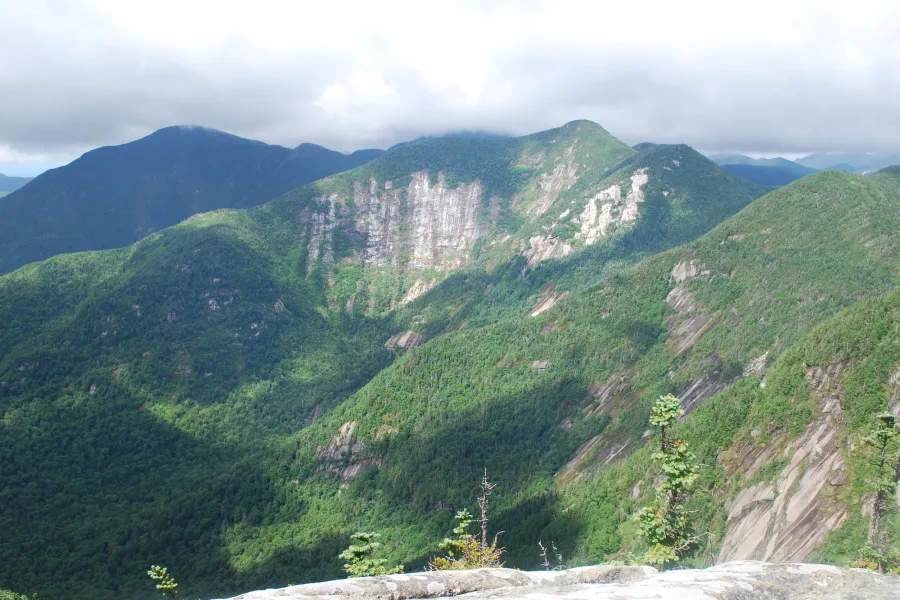 A mountain range with white cliff faces. 