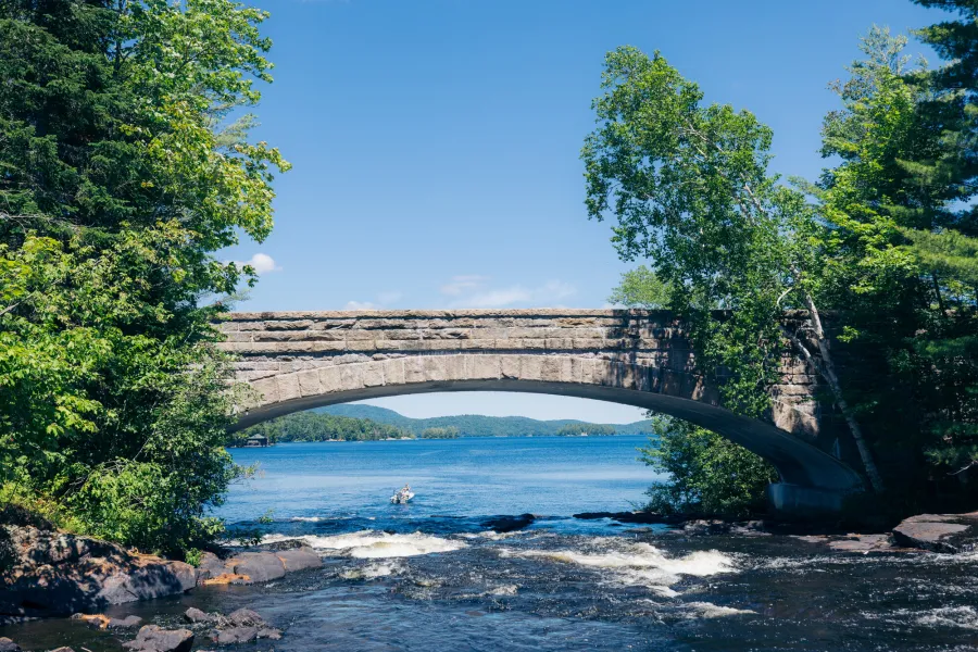 An arched bridge crosses over a river. 