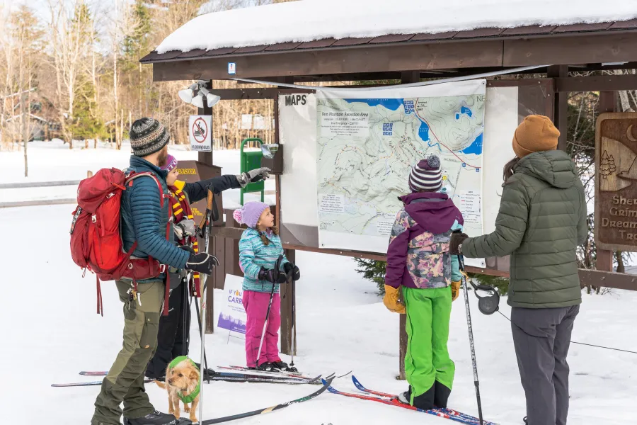 A family looking at a ski map at Fern Park Recreation Area.