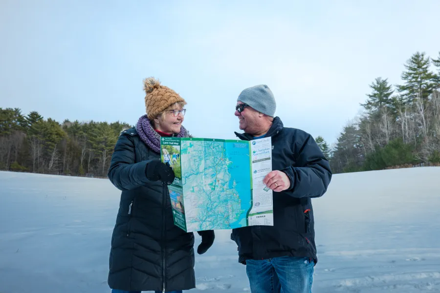 A couple looking at a map in winter.