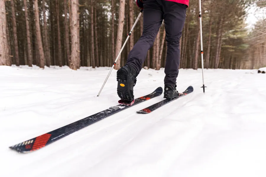 A close-up of someone cross-country skiing.